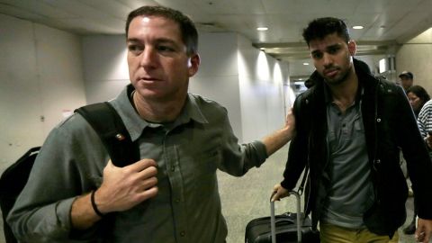 Journalist Glenn Greenwald  walks with his partner David Miranda in Rio de Janeiro's International Airport on August 19.