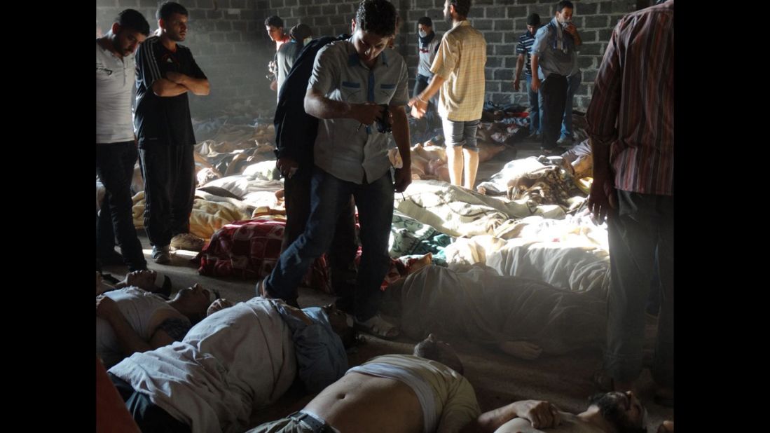 Syrian rebels claim pro-government forces used chemical weapons to kill citizens outside Damascus on Wednesday, August 21. People inspect bodies in this photo released by the Syrian opposition Shaam News Network.