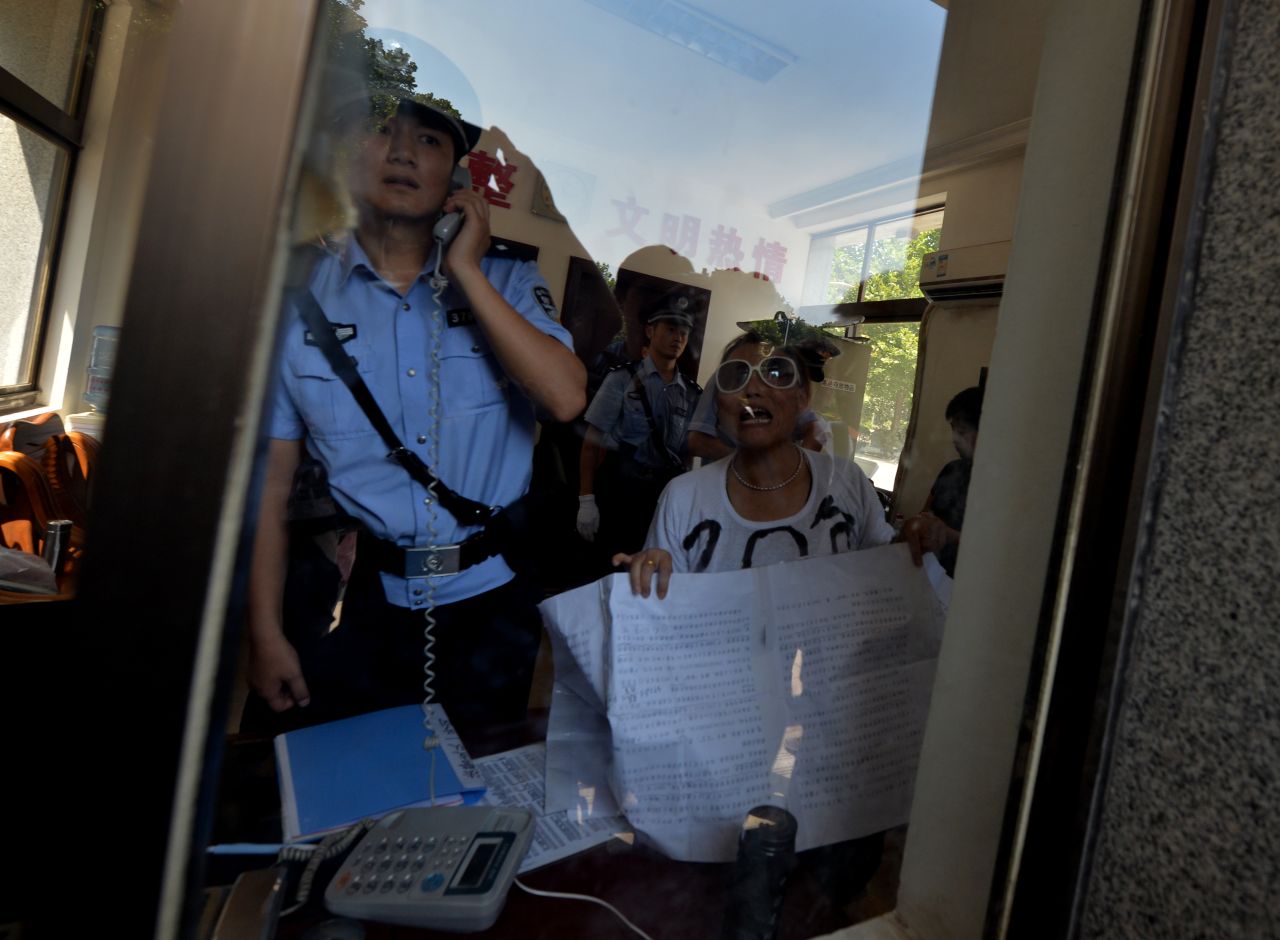 AUGUST 21 - JINAN, CHINA: Police detain a demonstrator who was protesting against China's justice system outside a court in Jinan, where <a href="http://cnn.com/2012/08/08/world/asia/china-bo-xilai-profile/index.html?iid=article_sidebar">disgraced politician Bo Xilai</a> will soon go on trial. Once considered a rising star in China's Communist Party, he is at the center of one of the country's most closely watched <a href="http://cnn.com/2013/08/18/world/asia/china-bo-xilai-trial-analysis/index.html?hpt=ias_t4">political scandals</a>.