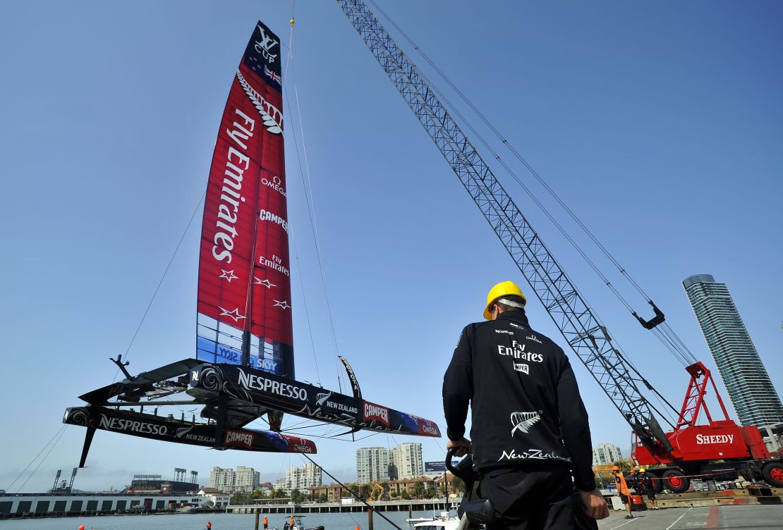 Team NZ's AC-72 racing yacht is lowered into San Francisco Bay for an 2013 America's Cup training session.
