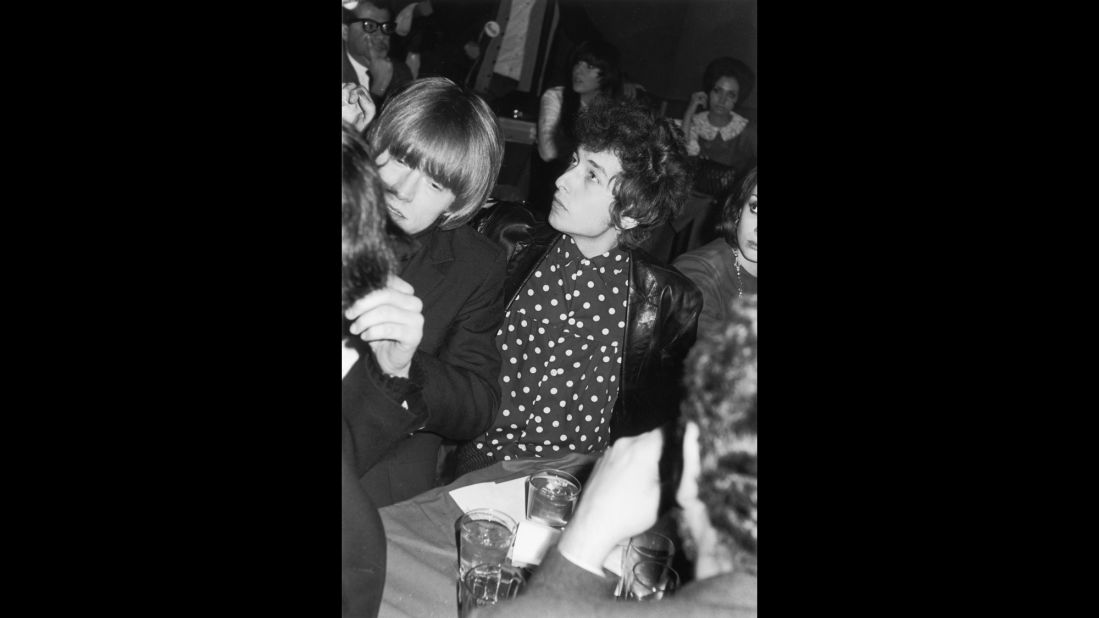 Brian Jones, left, from the Rolling Stones, and Bob Dylan attend a release party for a Young Rascals record, held by Bernstein at New York's Phone Booth nightclub in November 1965. 