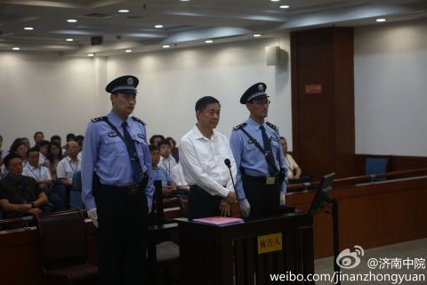 Fallen political star Bo Xilai stands for trial at the Jinan Intermediate People's Court on Thursday, August 22.       