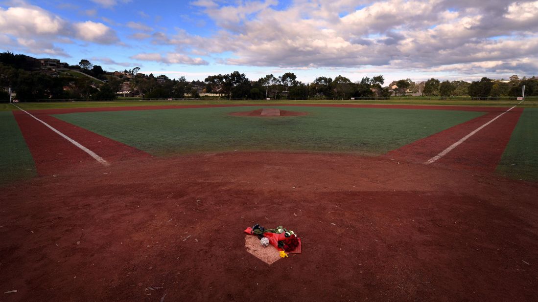 Flowers and a baseball lay on the Essendon Baseball Club's home plate as a tribute to Lane in Melbourne, Australia, on Wednesday, August 21.