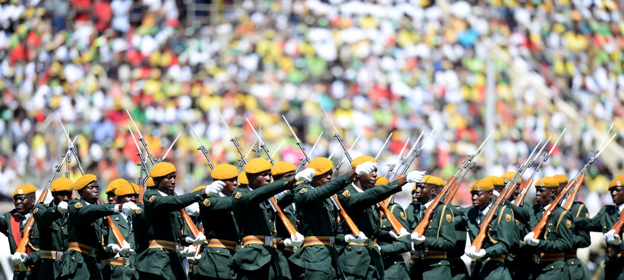 AUGUST 22 - HARARE, ZIMBABWE: Zimbabwean Guards of Honor march during <a href="http://cnn.com/2013/08/22/world/africa/zimbabwe-swearing-in/index.html">Robert Mugabe's swearing-in ceremony</a> at the 60,000-seater stadium in Harare. Supporters were clad in clothes emblazoned with the image of the <a href="http://cnn.com/2013/08/02/world/africa/mugabe-profile/index.html">veteran leader</a>, who has ruled the nation since 1980. The packed venue is a show of force after elections many say were rigged.