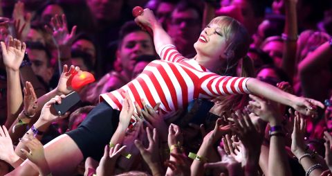 Taylor Swift has long been an artist of the people, but she strutted her stuff in little black shorty shorts and crowd-surfed during a performance of "We Are Never Ever Getting Back Together."