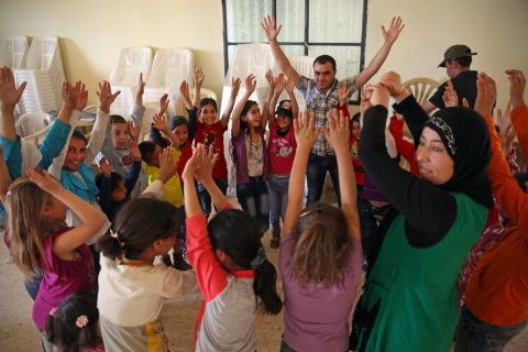 Syrian refugee children participate in co-operative games and collaborative storytelling to learn to move past painful experiences to trust one another and support their own health and well-being.