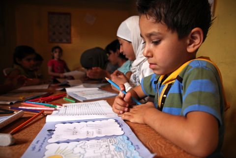Ibrahim, 6, attends Mercy Corps' "Comfort for Kids". The program is designed to help kids process trauma with an interactive workbook that helps them tell their story of the conflict in a safe environment.