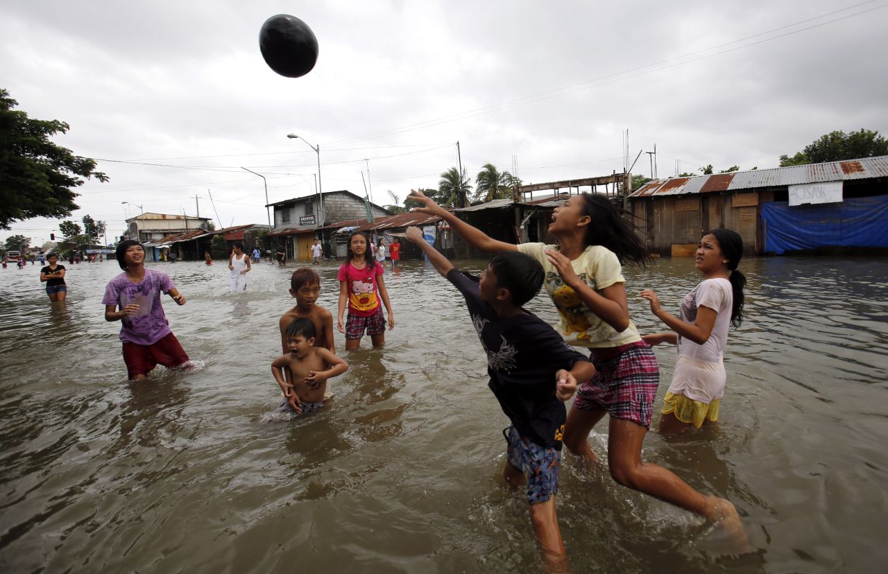People play volleyball on a flooded highway in Bulacan, Philippines, on August 22. 