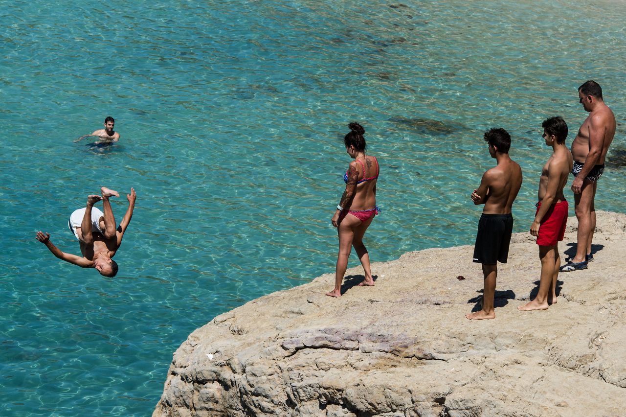 A man jumps into the sea in Cala Salada beach in Ibiza, Spain, on August 21. Each year thousands of young people gather to enjoy not only the hot weather and the beaches but also the array of clubs with international DJ's playing to vast audiences.