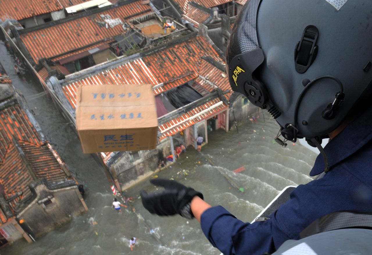A rescuer drops a box of food from a helicopter in Shantou, China, on August 21. 