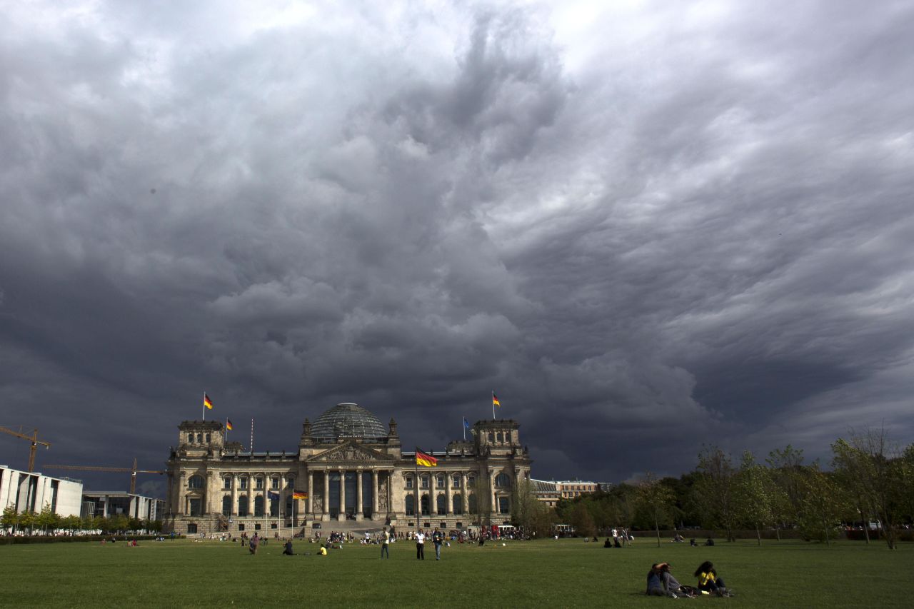 Dark clouds hang over Reichstag, the German parliament Bundestag building, in Berlin, on Tuesday, August 20. 