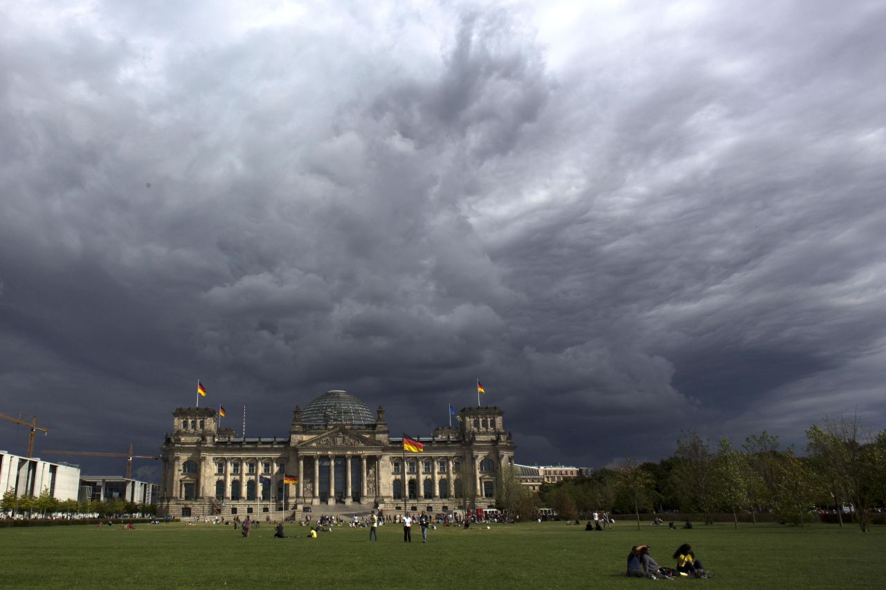 Dark clouds hang over Reichstag, the German parliament Bundestag building, in Berlin, on Tuesday, August 20.