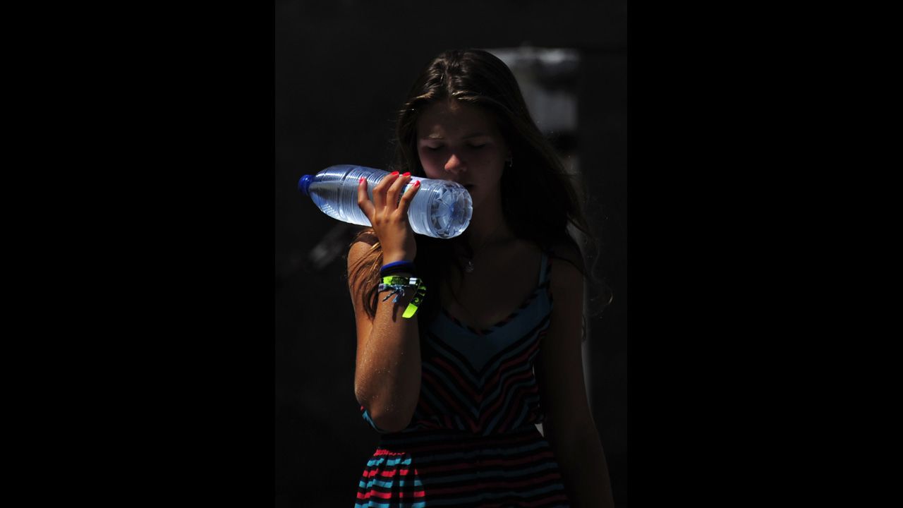 A girl cools off with a bottle of water in Seville, Spain, where temperatures exceeded 104 degrees Farhrenheit on August 20.