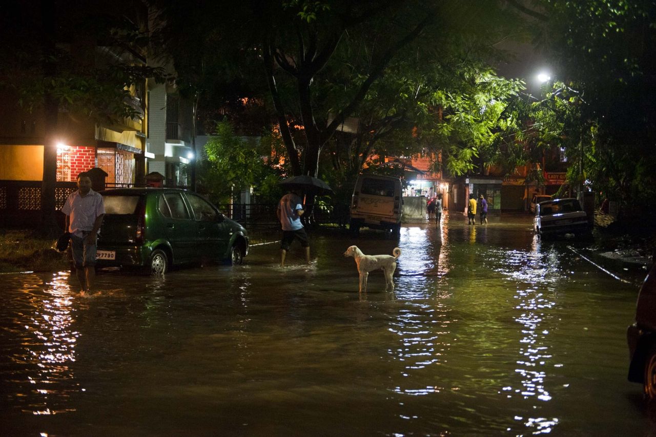 People wade through the streets of Kolkata, India, on August 20.