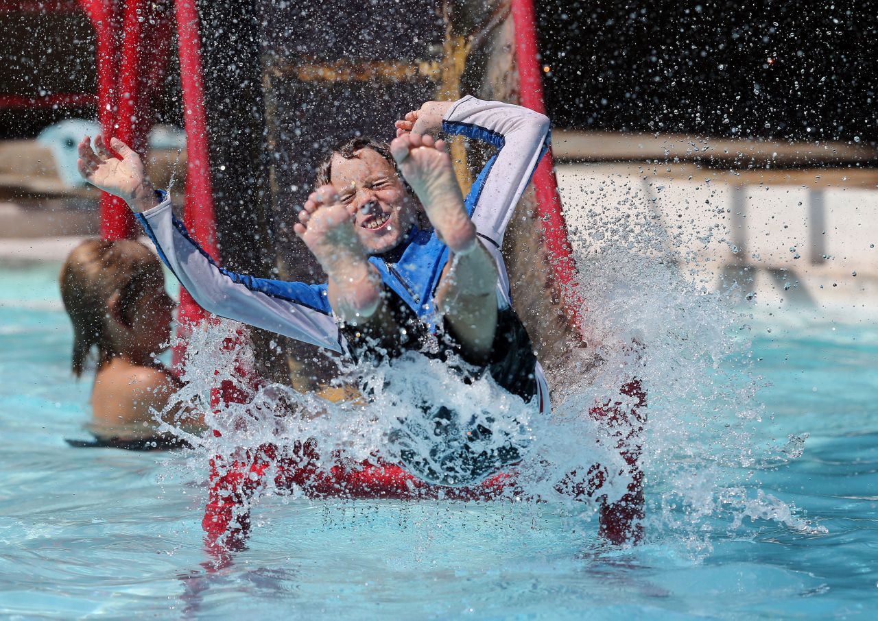 Brodie Bubel, 9, slides into the water at Eldorado Springs Pool & Resort, in Eldorado Springs, Colorado, on Monday August 19. 