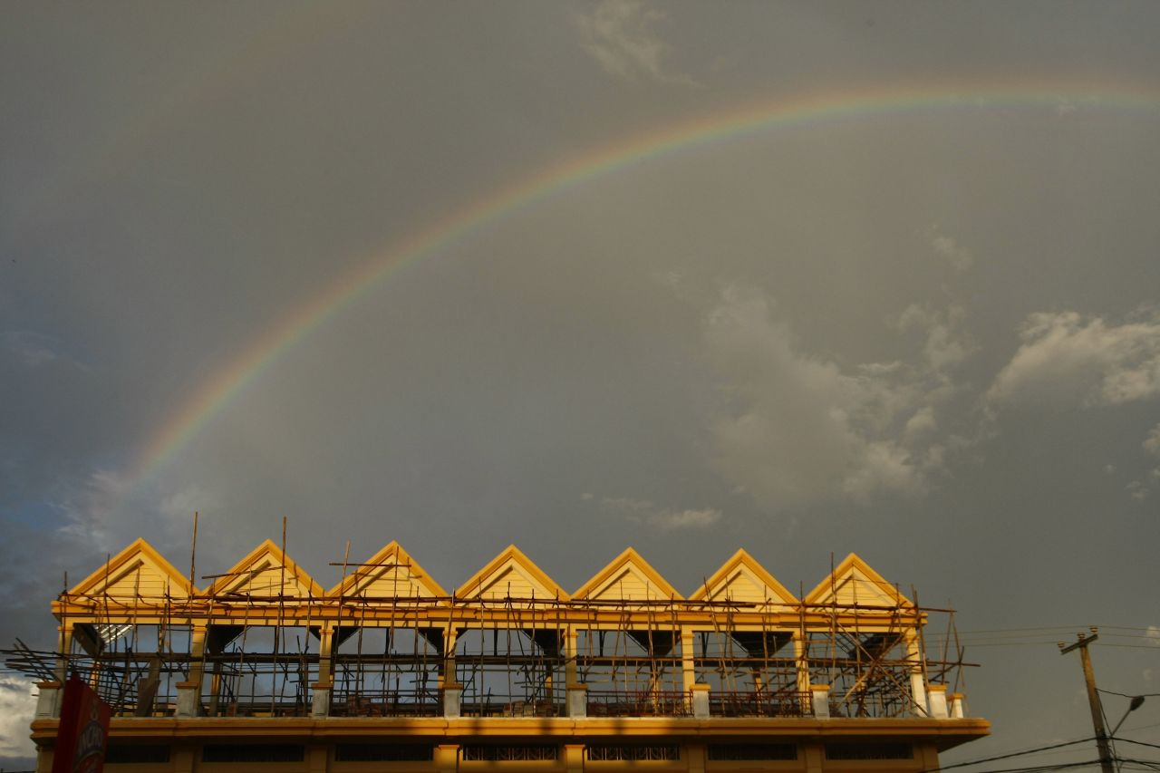 A rainbow appears over construction flats at a village of Krang Angkrong in Cambodia, on August 19.