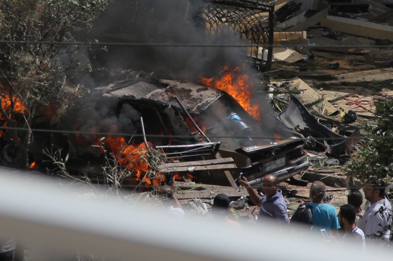 A car buns outside al Salam mosque, near the house of former Lebanese police chief Ashraf Rifi.