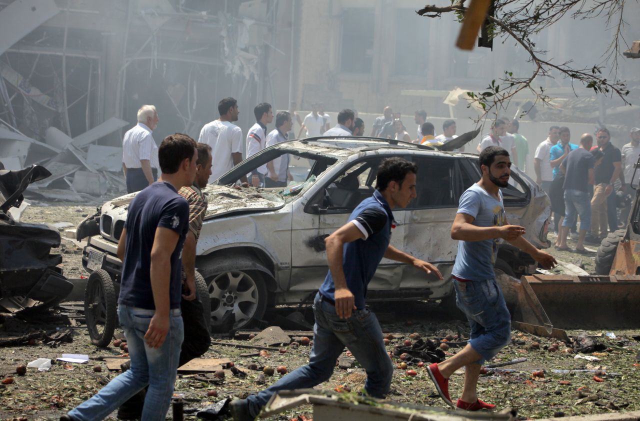 People gather outside the al Salam mosque. The blasts come amid sectarian tensions in Lebanon over the civil war in neighboring Syria.