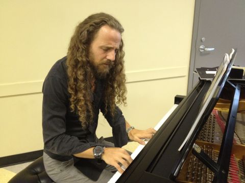 Nacho Arimany improvises on piano at the conference. He's collaborating with a company called Advanced Brain Technologies to compose music aimed at benefiting the brain. 