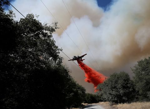 An air tanker drops fire retardant on a ridge ahead of the advancing Rim Fire on August 22, in Groveland, California. The Rim Fire continues to burn out of control and has entered Yosemite National Park.