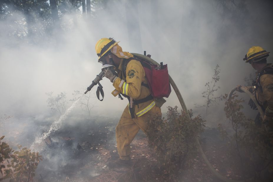 A Marin County firefighter works to put out a spot fire that jumped a fire line on the Rim Fire near Groveland, California, August 22.