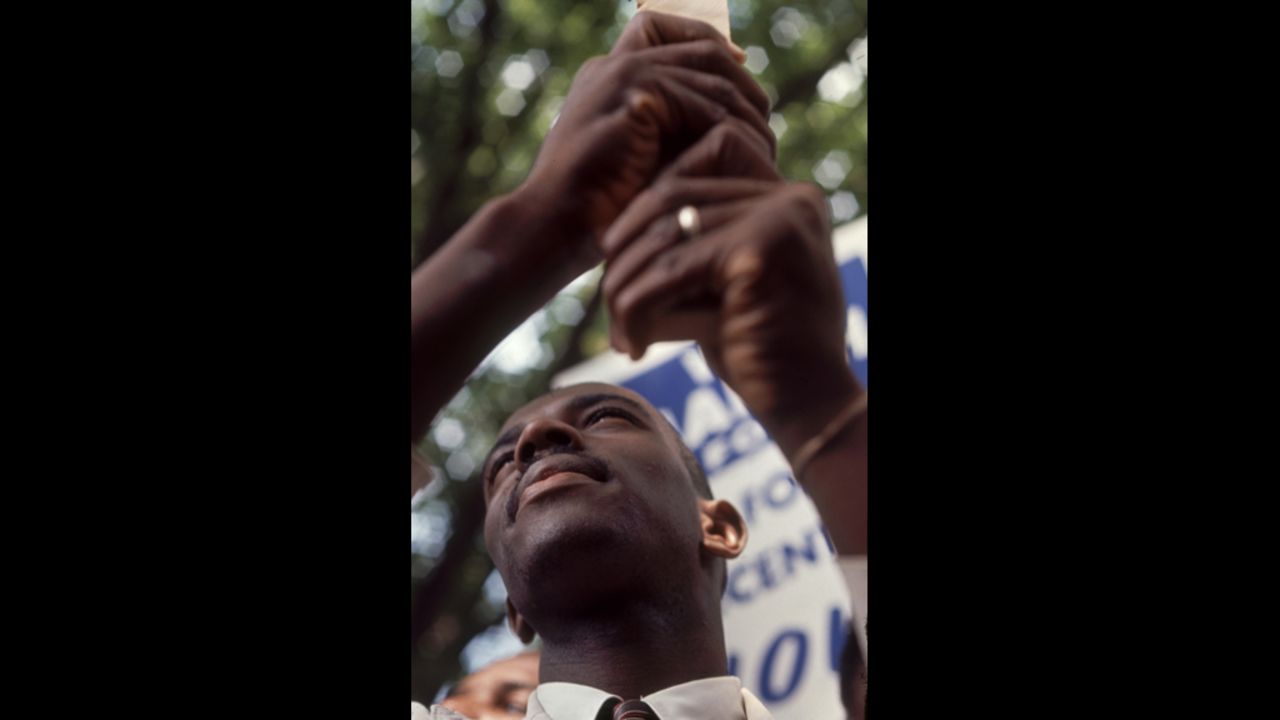 A demonstrator holds a protest sign at the rally.