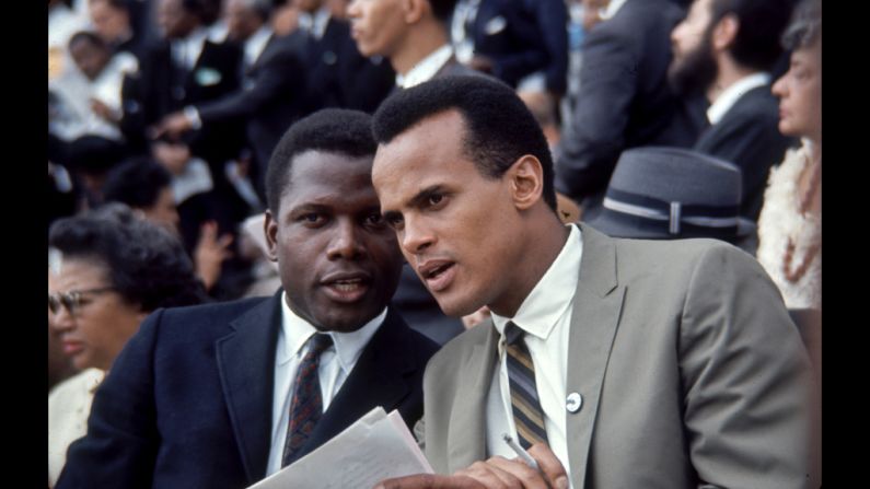 Actor Sidney Poitier, left, and Singer Harry Belafonte talk with one another during the march.