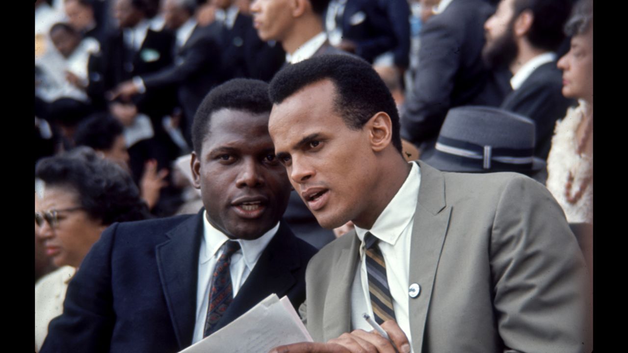 Actor Sidney Poitier, left, and Singer Harry Belafonte talk with one another during the march.