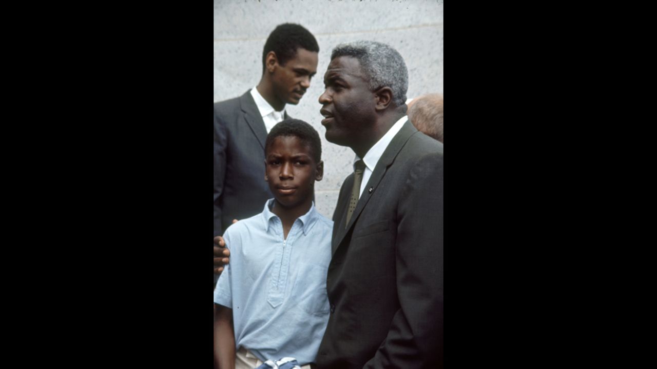 Baseball player Jackie Robinson, right, attends the rally with his son David.