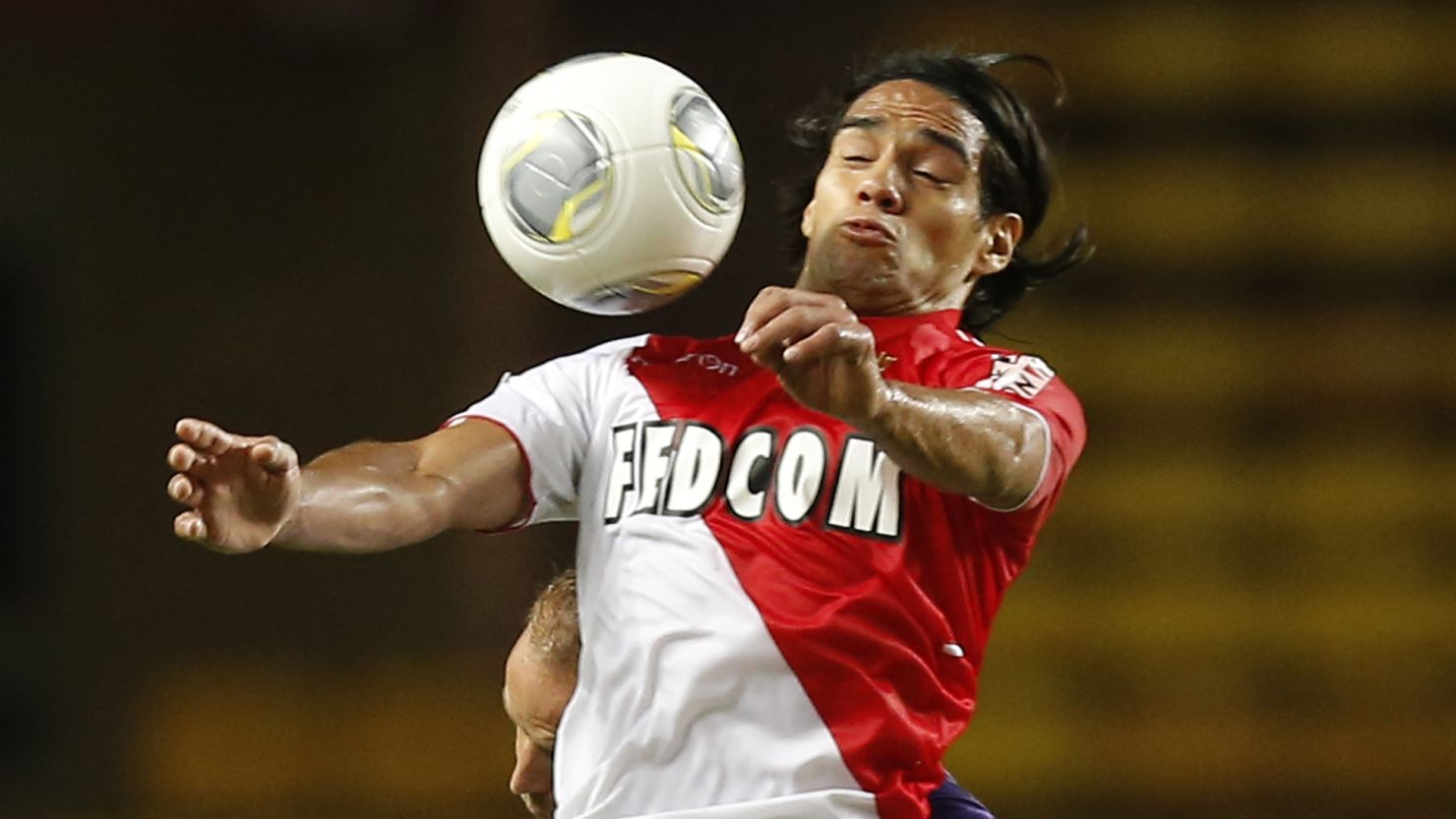 Monaco's Radamel Falcao battles for the ball in front of empty stands in their home match against Toulouse.