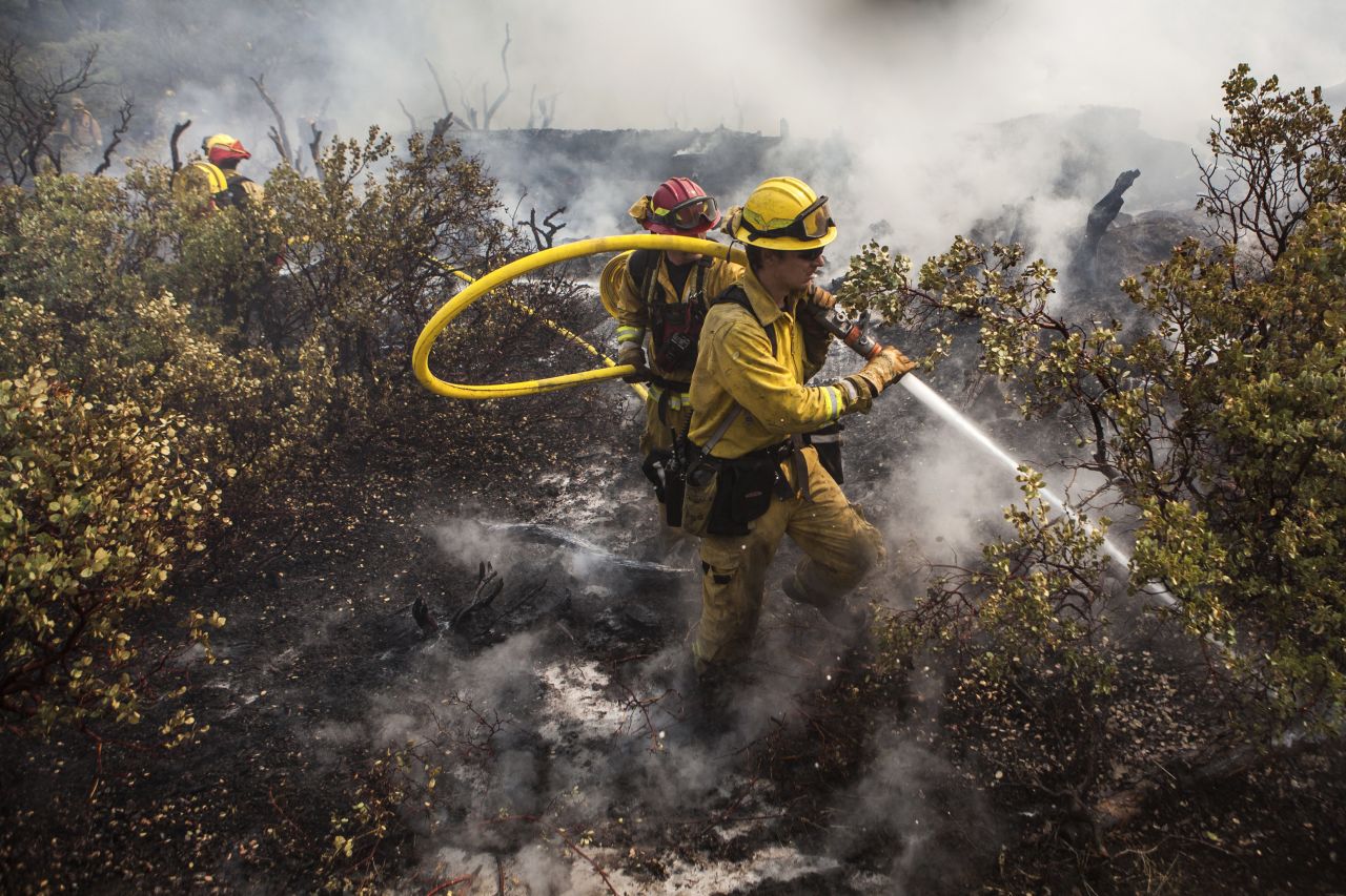 A firefighting crew puts out a spot fire that jumped a fire line in Yosemite National Park on August 23.
