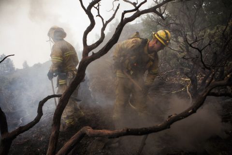 El Dorado Hills firefighters work to douse a hotspot in Yosemite National Park on August 24. Nearly 5,000 firefighters are attempting to bring the fast-moving fire under control. 