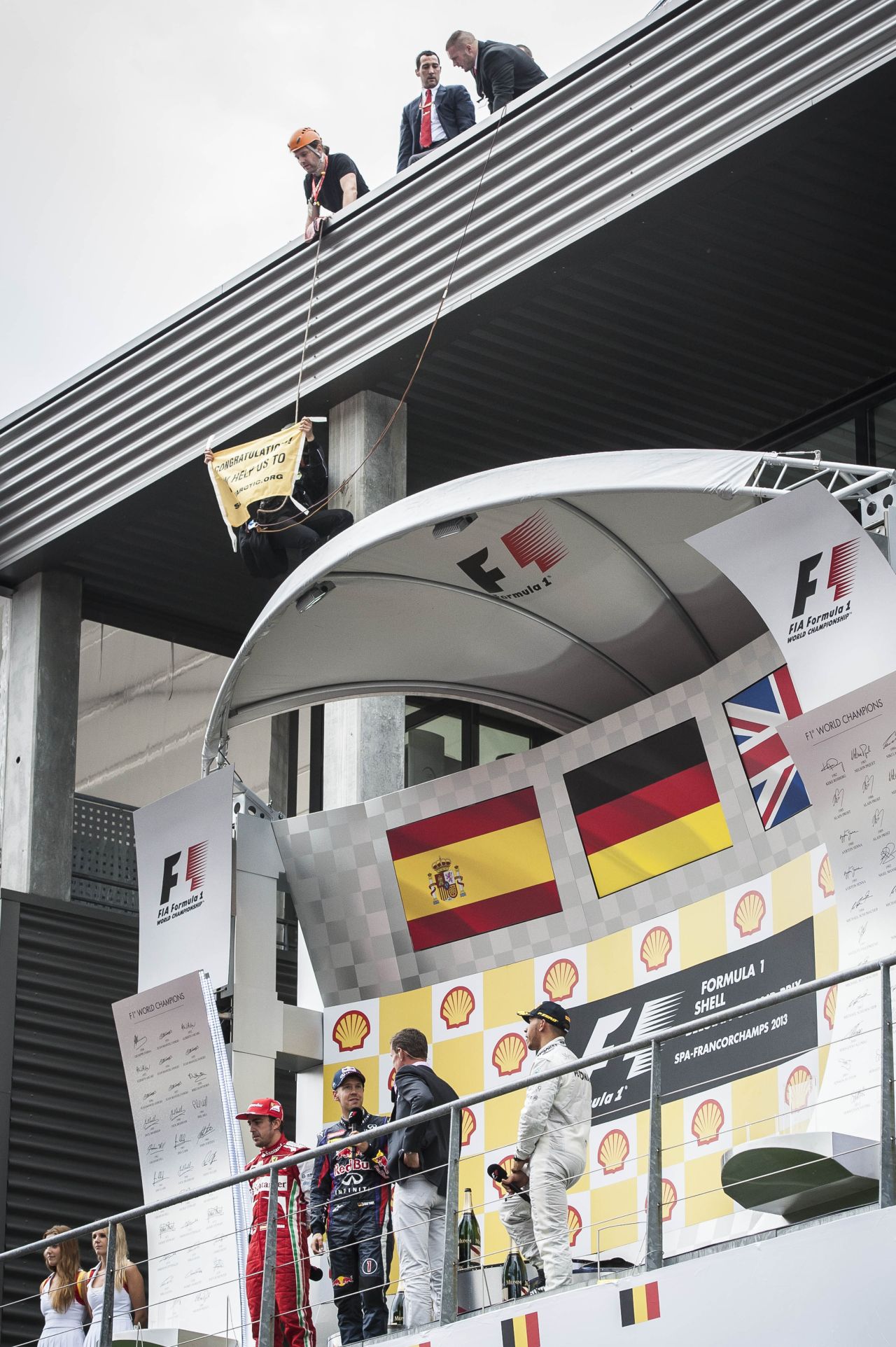 A member of Greenpeace also managed to unfurl a banner above the winner's podium at the end of the race, where  drivers Sebastian Vettel, Fernando Alonso and Lewis Hamilton addressed the crowd.