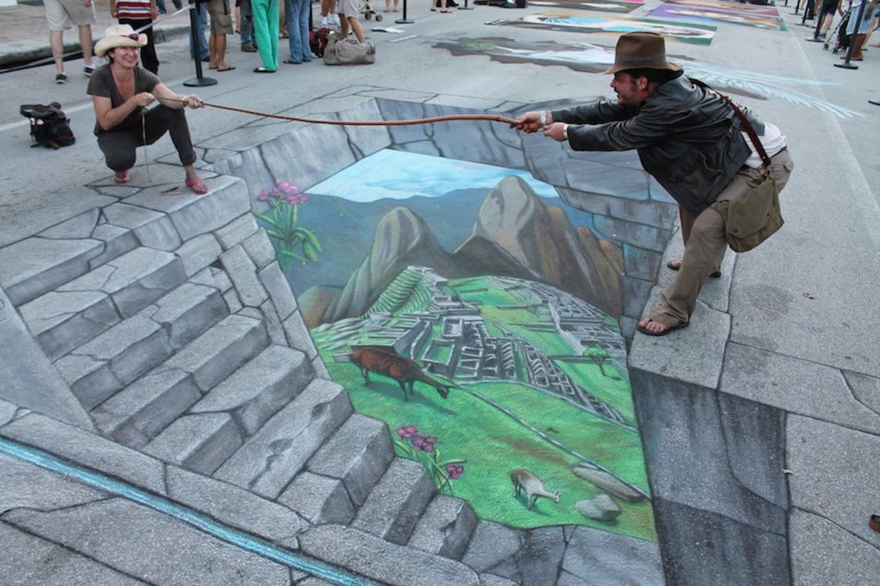 Tracy Lee Stum pulls fellow artist Kelly McClain into her 3D image of Machu Picchu in Lake Worth, Florida.