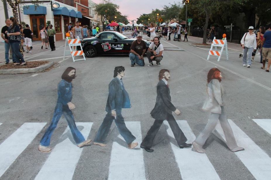 Artists Hector Diaz, left, and Ken Mullen overlook their recreation of the Beatles' Abbey Road album cover in Lake Worth, Florida.