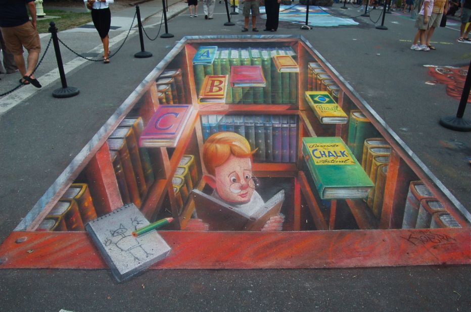 Artist Edwardo Kobra made this 3-D image of a young boy studying chalk art in Sarasota, Florida.
