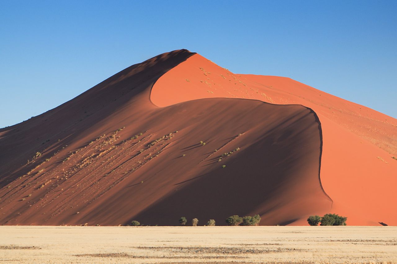 With its red sand dunes and white salt pans, Namibia's Namib Desert looks so Martian that it wouldn't come as a shock if the Curiosity Rover rumbled over a dune. 