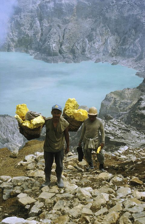 Workers on Kawah Ijen, a volcanic lake in Java, Indonesia, collect sulfur to sell to a refinery. Conditions are treacherous, pungent smoke billows from gashes in the ground and at least one tourist is reported to have died while climbing down the crater. But local miners spend hours here each day mining sulfur, earning around $10 a day.