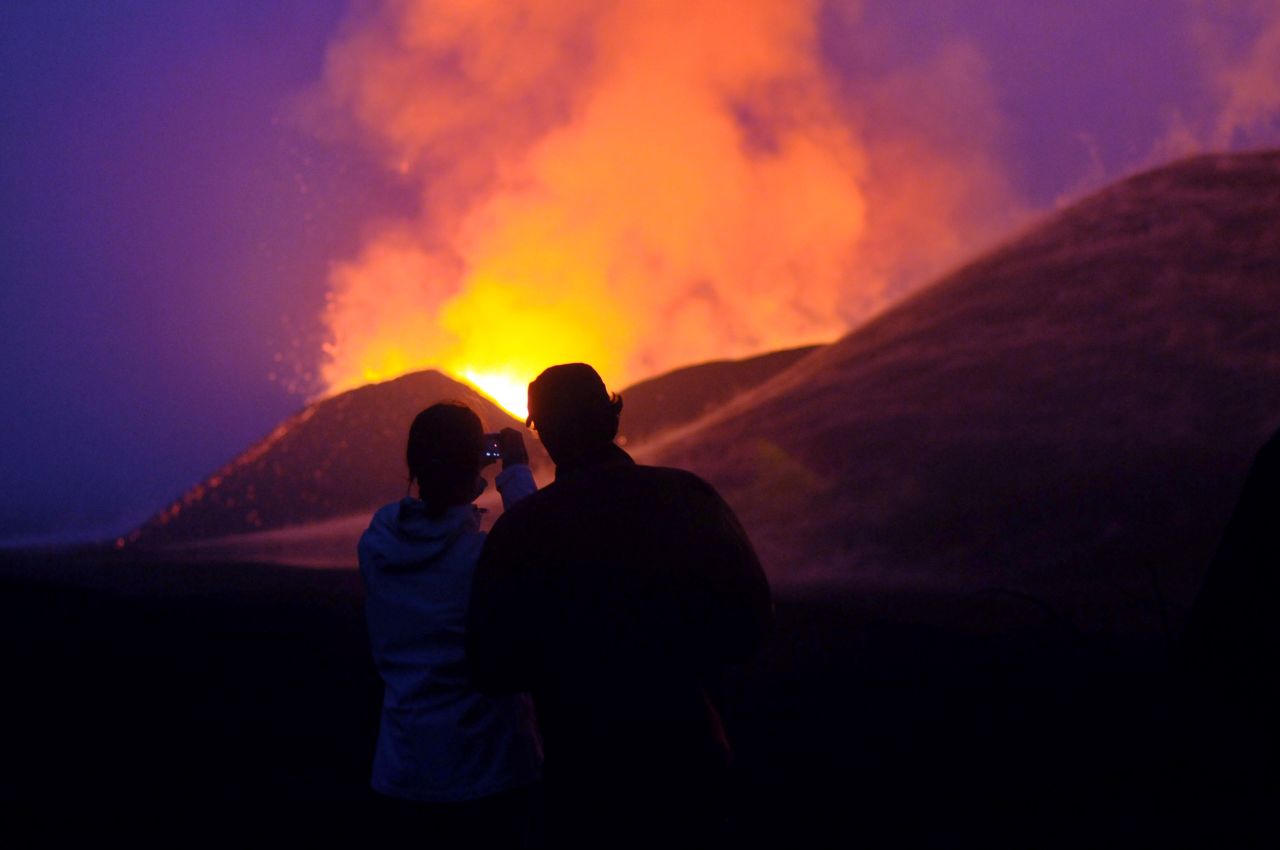 Tampa says Congo has the potential to be a huge tourist attraction, creating jobs and businesses for the region. Tourists take a photo of a volcanic eruption at the Virunga National Park, near Goma.