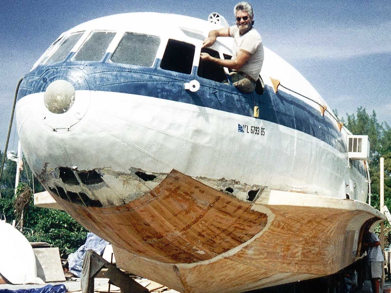Owner Dave Drimmer, rebuilding the hull of his "planeboat" in 1994.