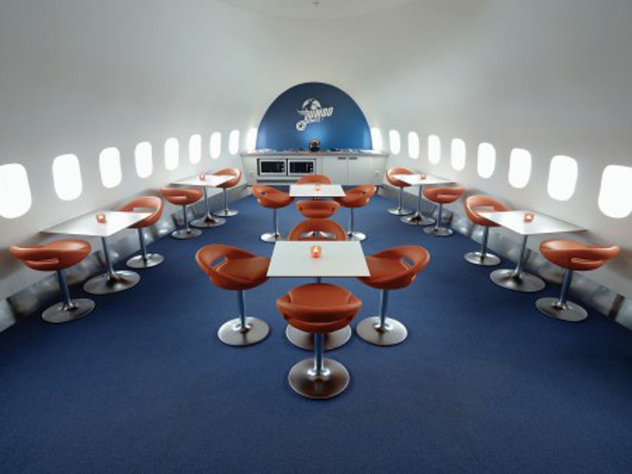 With commercial seats removed, airplanes look surprisingly larger inside. This is the dining area at Jumbo Stay.
