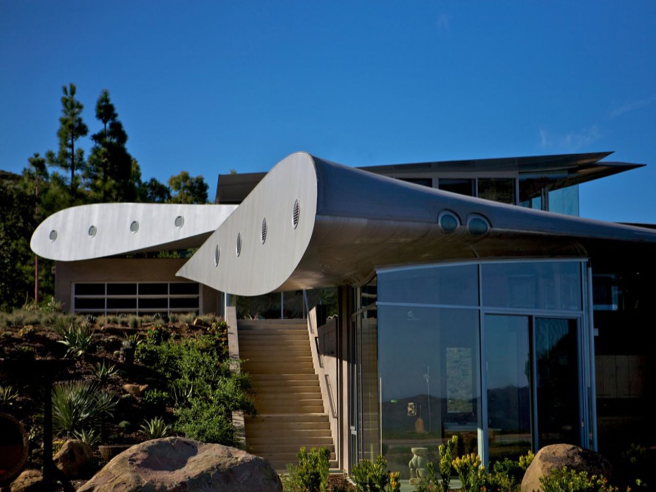 Architect David Hertz designed this Wing House in Malibu from the wing of a Boeing 747 for a client who requested "curvilinear, feminine shapes." While the roof looks durable, we're wondering what it sounds like when it rains.