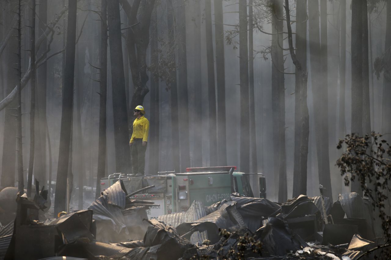 A firefighter stands on top of a fire truck at a campground destroyed by the Rim Fire near Yosemite National Park on August 26. The massive wildfire grew during the week and became the 5th largest in state history, state fire authorities said.