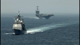 A picture released by the US Navy shows the guided-missile cruiser USS Gettysburg (CG 64) (L) and the aircraft carrier USS Harry S. Truman (CVN 75) transiting the Strait of Gibraltar on August 3, 2013 on their way to the Mediterranean Sea. US forces are "ready to go" if called on to strike the Syrian regime, Defense Secretary Chuck Hagel told the BBC on August 27, 2013, saying evidence pointed to its use of chemical weapons. The Pentagon chief said forces had been deployed as needed and President Barack Obama had reviewed military options presented by commanders. AFP PHOTO/US NAVY - Jamie Cosby