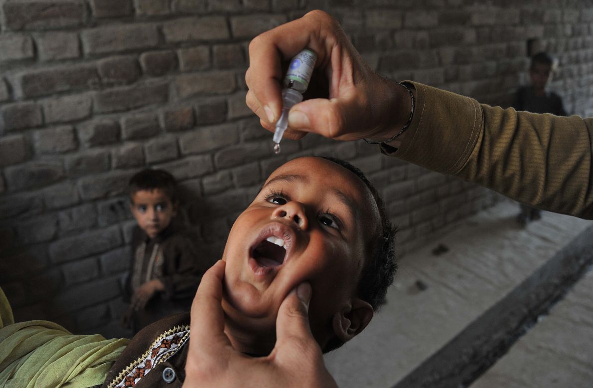 AUGUST 27 - JALALABAD, AFGHANISTAN: A health worker administers polio vaccine drops to an Afghan child. <a href="http://cnn.com/2012/07/27/health/polio-eradication-efforts">Polio</a>, once a worldwide scourge, is endemic in just three countries now -- Nigeria, Afghanistan and Pakistan. But the global goal to <a href="http://cnn.com/2012/10/02/health/time-un-polio">eradicate polio by 2015</a> is threatened by frequent <a href="http://cnn.com/2013/05/28/world/asia/pakistan-polio-workers-attack">attacks on the health workers</a> giving the vaccination.
