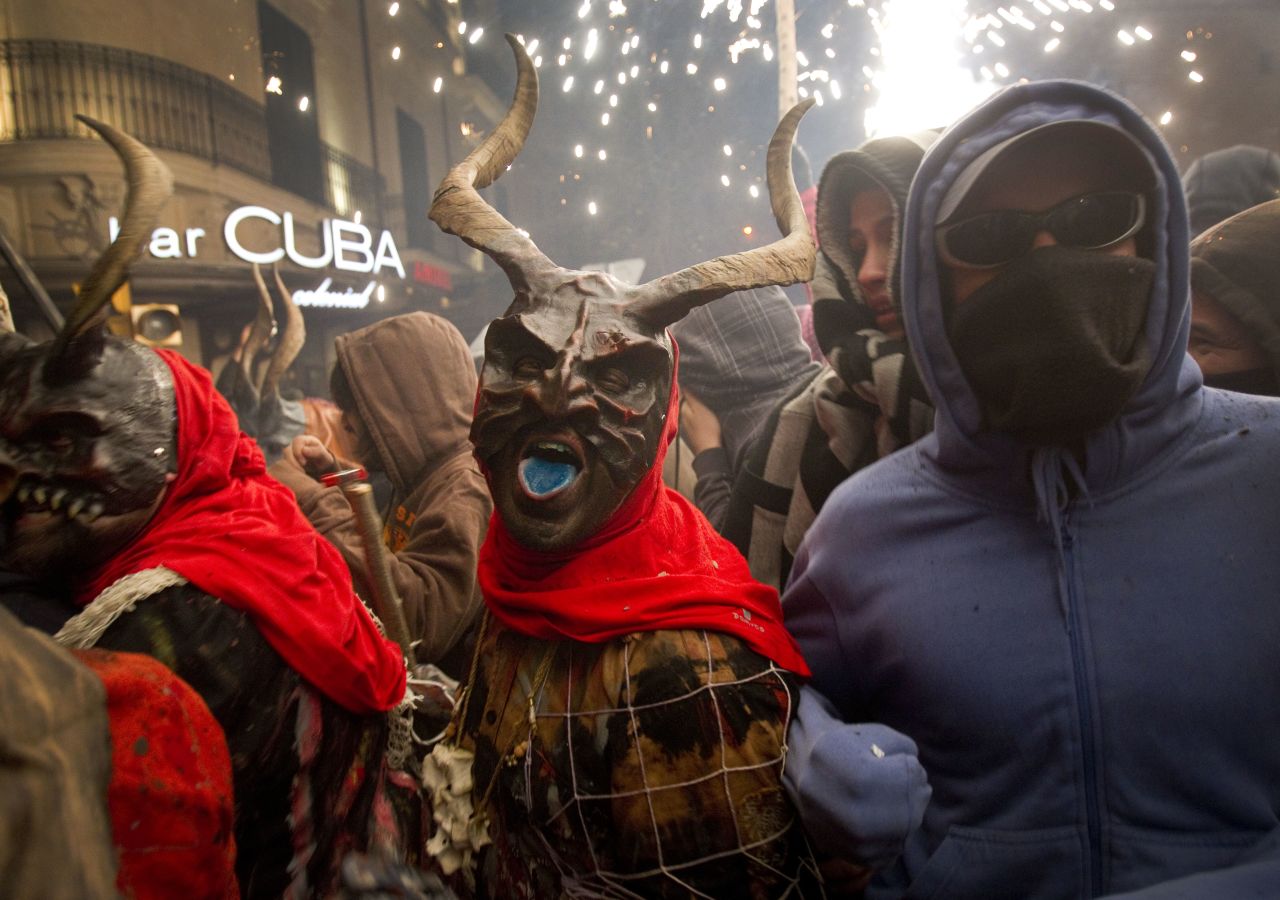 A reveler wearing a demon costume takes part in the traditional festival of Correfoc in Palma de Mallorca. Participants dress as demons and devils and move through the streets scaring people with fire and fireworks.