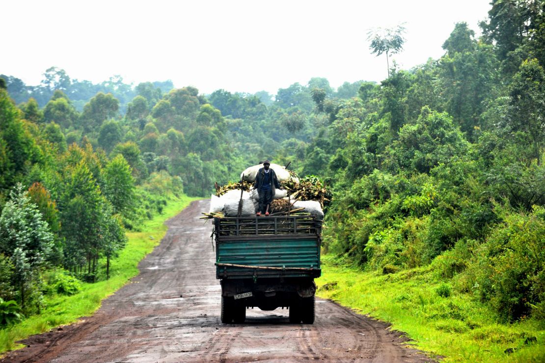 A man stands on the back of a truck in Rumangabo. Virunga is a picturesque backdrop to one of the most violent and longest runing armed conflict. 