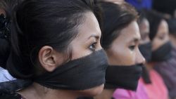 Photojournalists, with black bands around their mouth, participate in a protest against the gang rape of a photojournalist in Mumbai, in Gauhati, India, Saturday, Aug. 24, 2013. 
