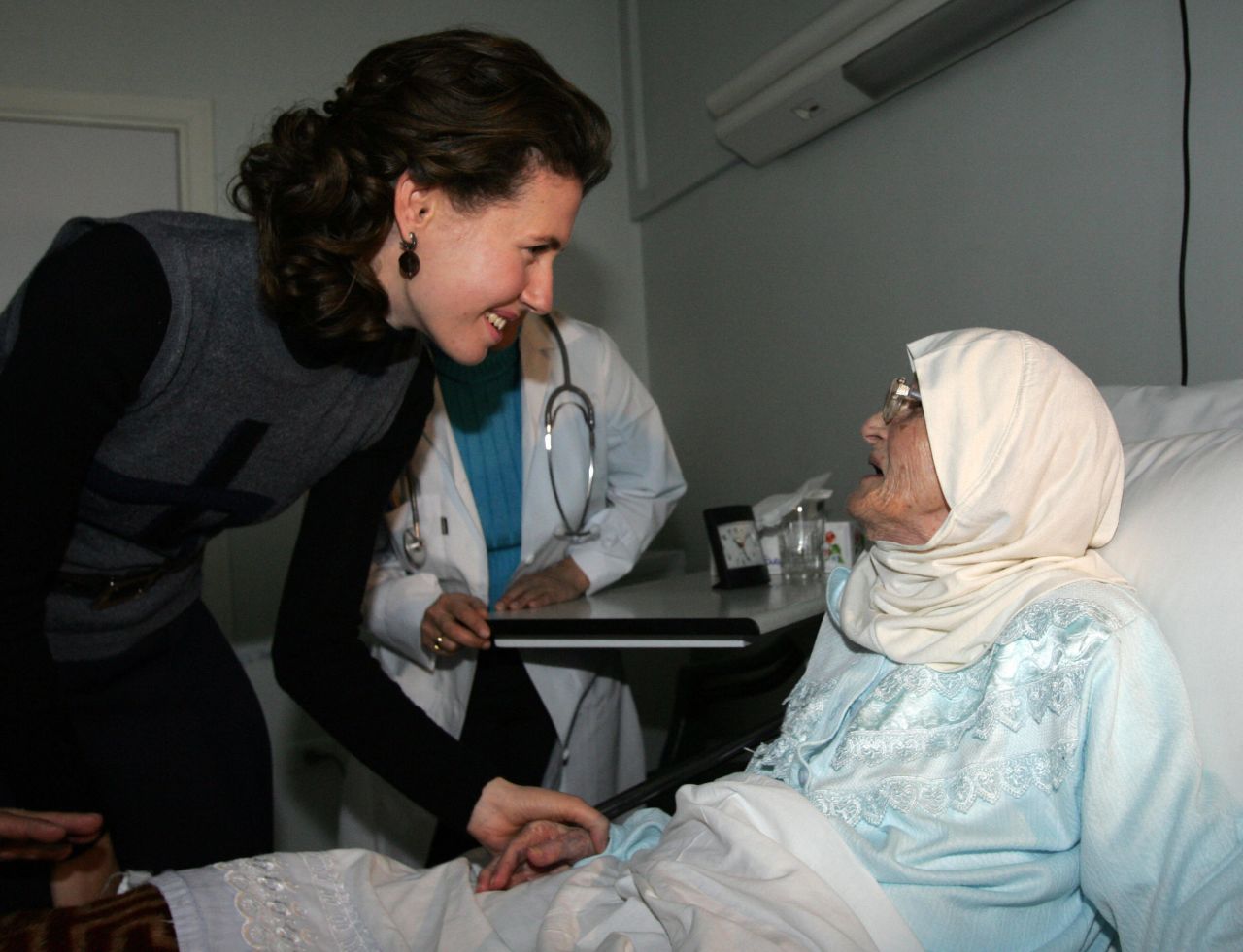 On the first day of the Eid al-Adha, Asma al-Assad visits a resident at a home for the elderly in Damascus, on December 19, 2007.