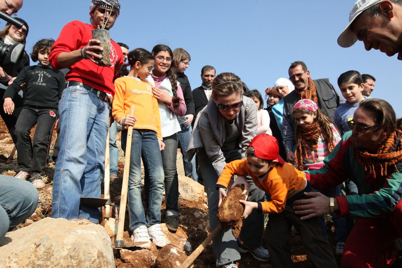 Al-Assad plants trees with children during a tree planting campaign in Yafour, Syria, on December 5, 2009. Over 3,000 trees, including pine, cypress, linden and wild pear, were planted.
